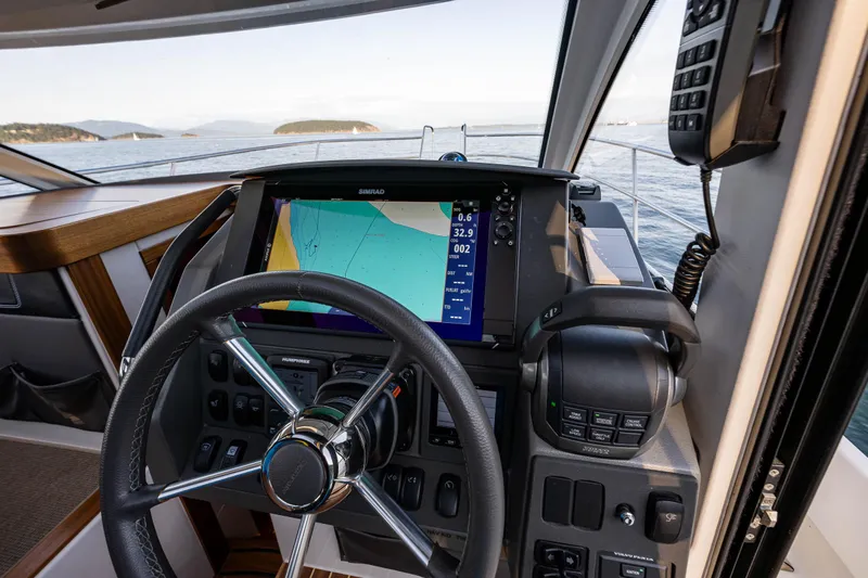 Keokuk Yacht Photos Pics 2020 Nimbus 365 Coupe cockpit with navigation system and steering wheel.