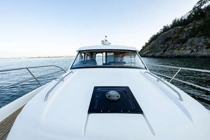 Keokuk Yacht Photos Pics Nimbus 365 Coupe 2020 yacht cruising near rocky shoreline.
