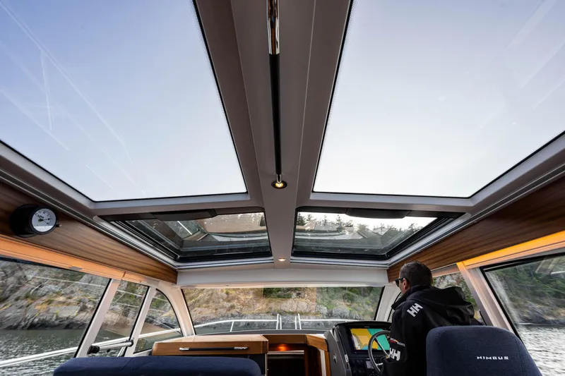 Keokuk Yacht Photos Pics Interior view of 2020 Nimbus 365 Coupe with panoramic sunroof and modern dashboard.