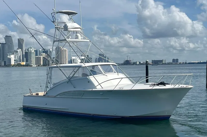  Yacht Photos Pics 1993 Buddy Davis 38 Express yacht docked with city skyline in background.