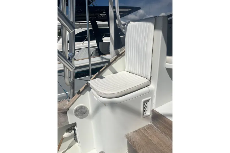  Yacht Photos Pics White cushioned seat on 1993 Buddy Davis 38 Express boat, near stainless steel railings.