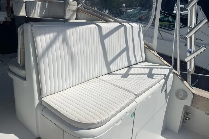  Yacht Photos Pics White cushioned seating on a 1993 Buddy Davis 38 Express boat deck.