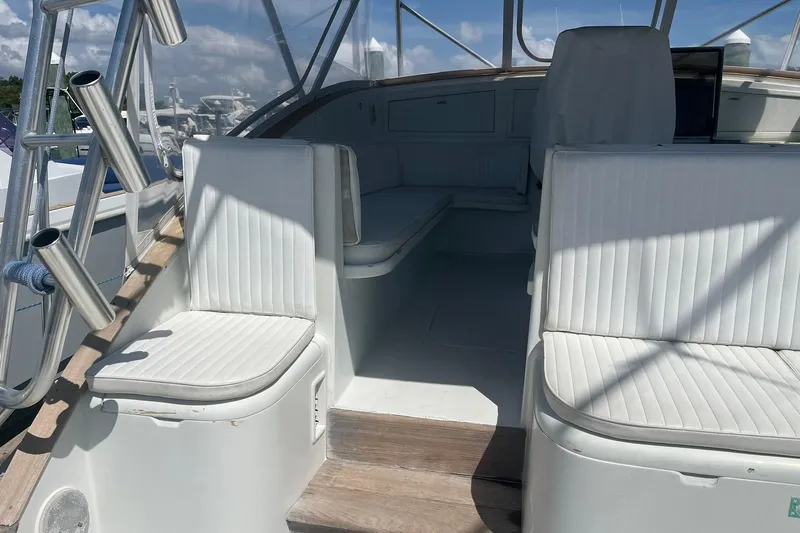  Yacht Photos Pics 1993 Buddy Davis 38 Express boat interior with white seating and wooden flooring.