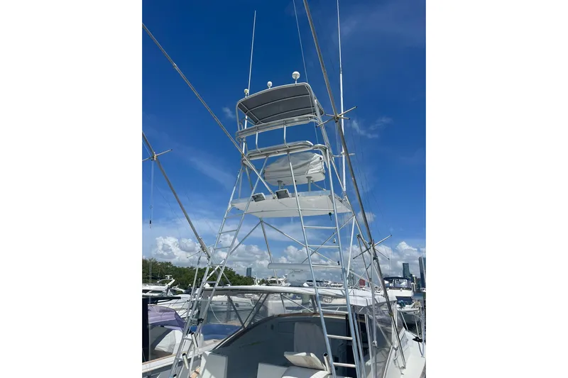  Yacht Photos Pics 1993 Buddy Davis 38 Express boat with tower against a clear blue sky.