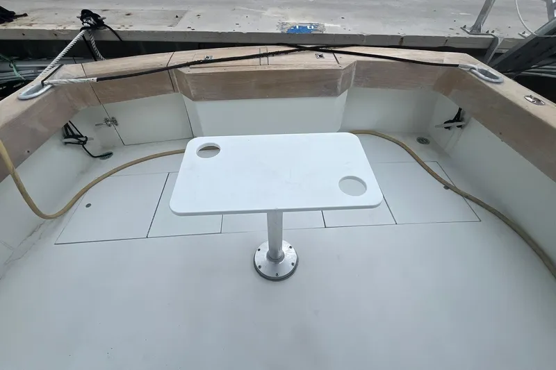  Yacht Photos Pics 1993 Buddy Davis 38 Express boat deck with white table and seating area.