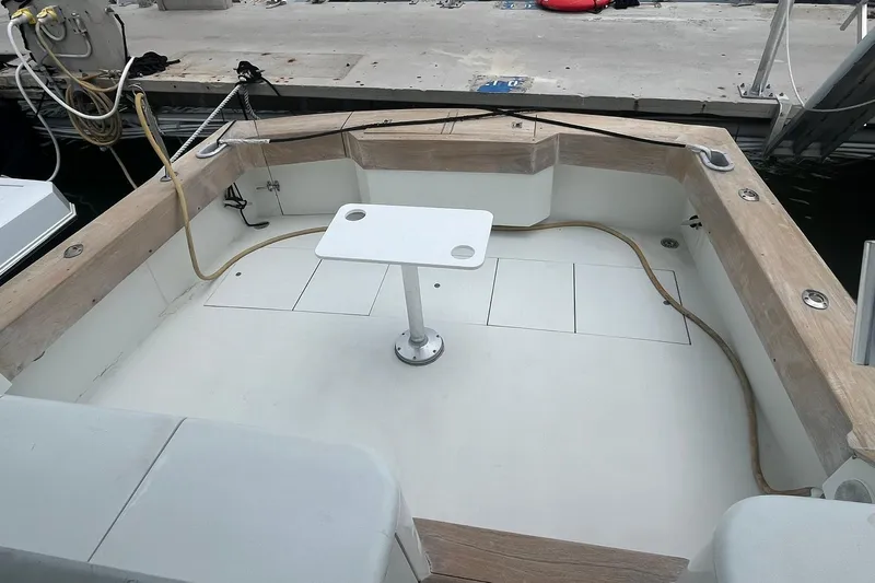  Yacht Photos Pics 1993 Buddy Davis 38 Express boat deck with table and seating at dock.