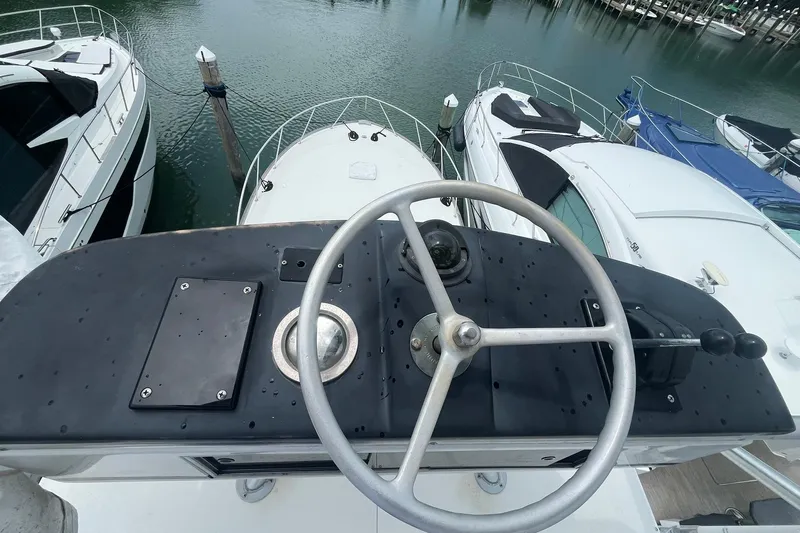  Yacht Photos Pics Helm of 1993 Buddy Davis 38 Express yacht, docked among other boats.