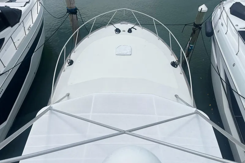  Yacht Photos Pics Overhead view of a 1993 Buddy Davis 38 Express boat docked between two others.