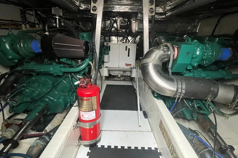  Yacht Photos Pics Engine room of a 1993 Buddy Davis 38 Express boat with visible machinery and fire extinguisher.