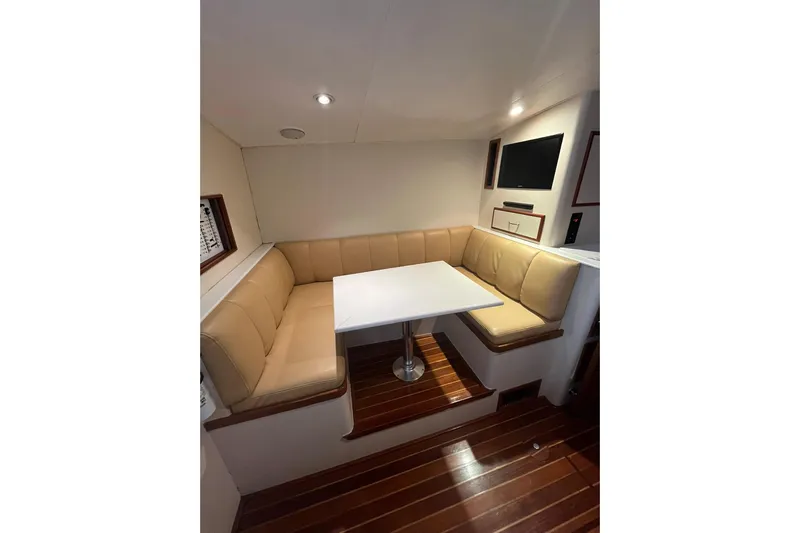  Yacht Photos Pics Interior of 1993 Buddy Davis 38 Express with beige seating and white table.