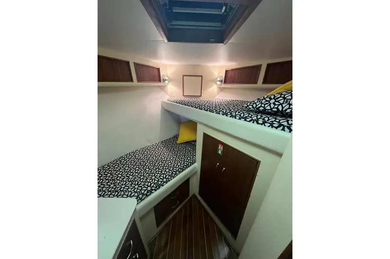  Yacht Photos Pics Interior cabin of 1993 Buddy Davis 38 Express with bunk beds and patterned bedding.