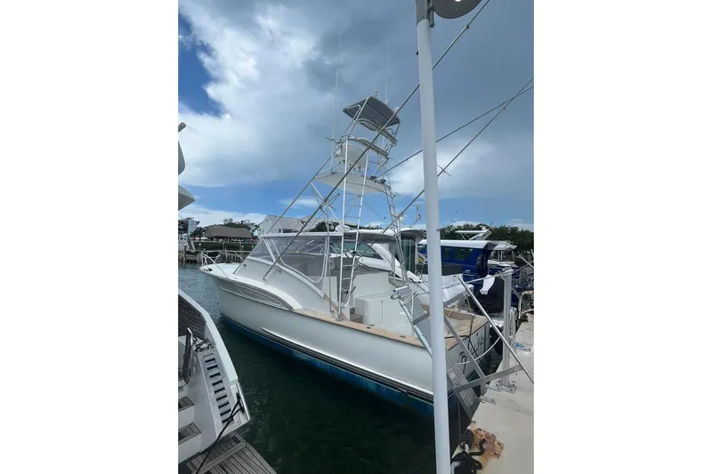  Yacht Photos Pics 1993 Buddy Davis 38 Express boat docked under cloudy sky.