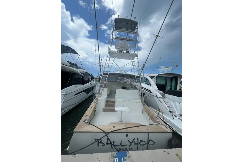  Yacht Photos Pics 1993 Buddy Davis 38 Express boat docked, featuring a tall tower and open deck.
