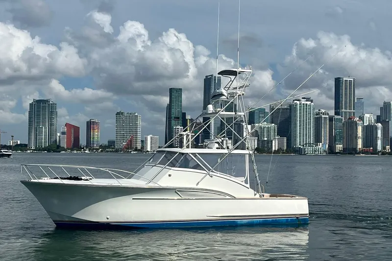  Yacht Photos Pics 1993 Buddy Davis 38 Express yacht with city skyline backdrop.