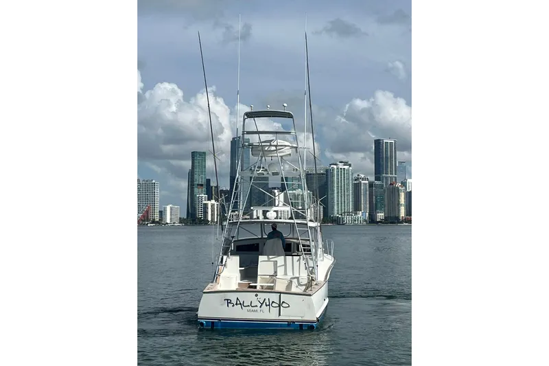  Yacht Photos Pics 1993 Buddy Davis 38 Express boat in Miami waters with city skyline backdrop.