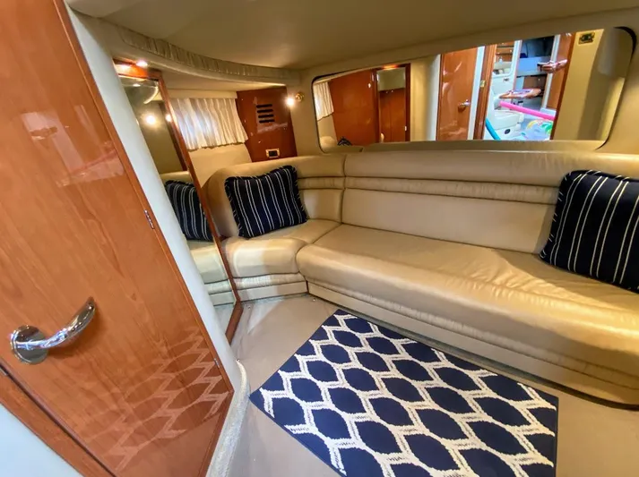  Yacht Photos Pics Luxurious interior of 2001 Sea Ray 460 Sundancer yacht with beige seating and navy accents.