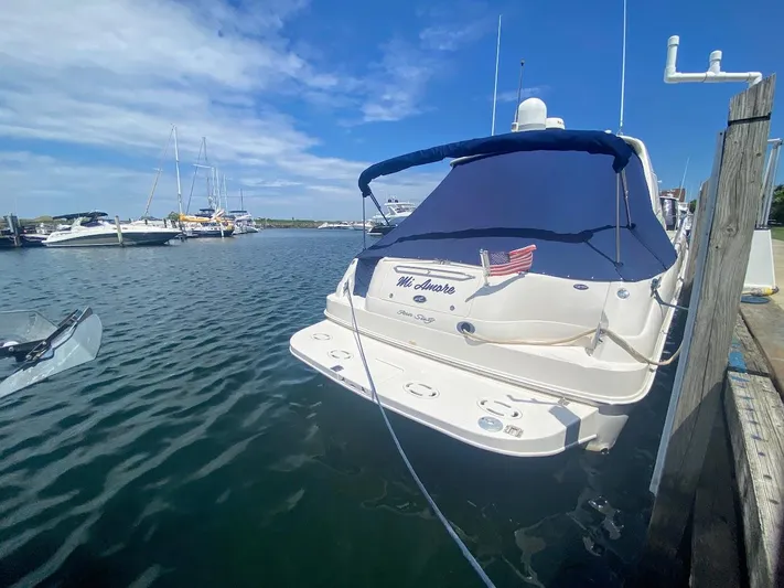  Yacht Photos Pics 2001 Sea Ray 460 Sundancer yacht docked in a marina under a clear blue sky.
