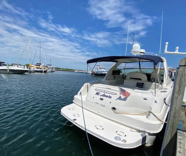 Yacht Photos Pics 2001 Sea Ray 460 Sundancer yacht docked in a marina under a clear blue sky.