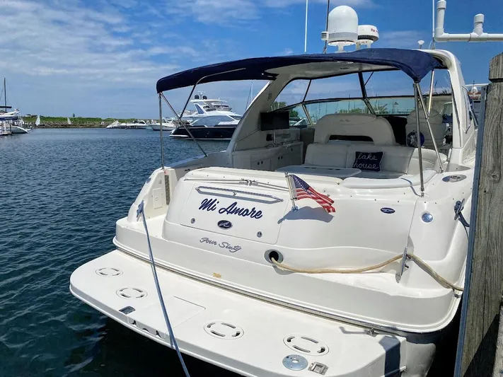  Yacht Photos Pics 2001 Sea Ray 460 Sundancer yacht docked, featuring a sleek design and American flag.