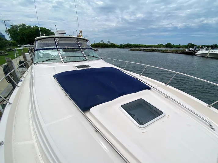  Yacht Photos Pics 2001 Sea Ray 460 Sundancer yacht on calm water under cloudy sky.