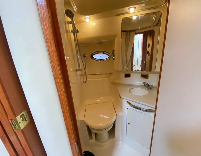  Yacht Photos Pics Bathroom interior of 2001 Sea Ray 460 Sundancer yacht, featuring shower, toilet, and sink.