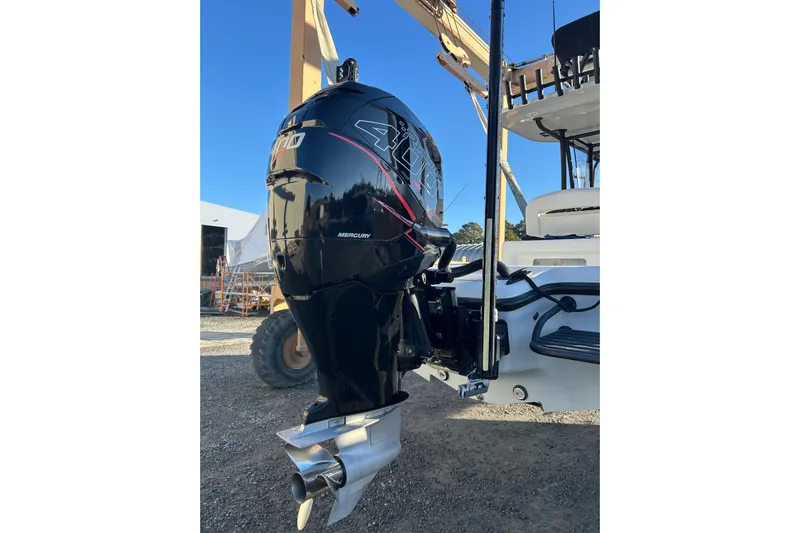  Yacht Photos Pics 2017 Baker Boatworks 26 Open with Mercury outboard engine, parked outdoors.