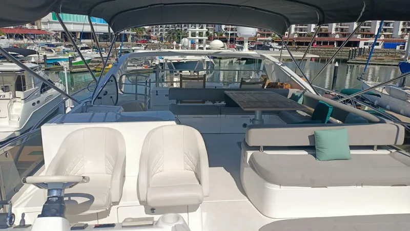 La Chaparrita Yacht Photos Pics 2011 Sunseeker Manhattan 70 yacht interior with seating and helm, docked at marina.