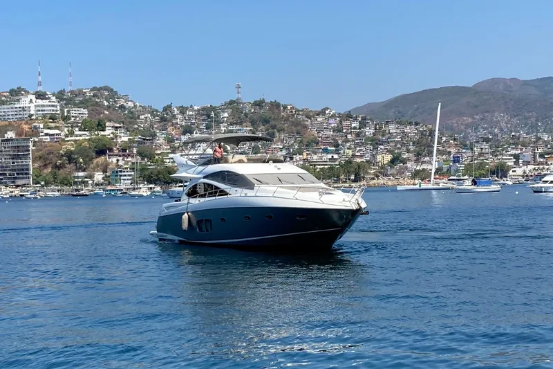 La Chaparrita Yacht Photos Pics 2011 Sunseeker Manhattan 70 yacht cruising in a scenic coastal area.