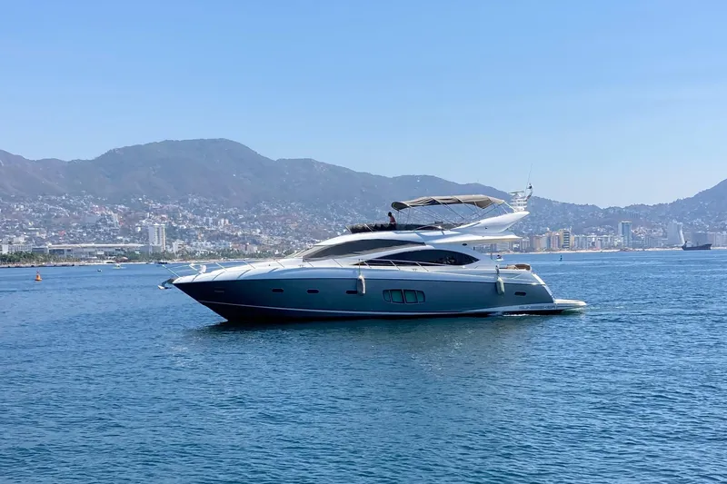 La Chaparrita Yacht Photos Pics 2011 Sunseeker Manhattan 70 yacht cruising on a scenic coastal waterway.