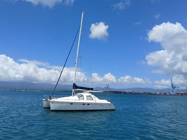 Osina Yacht Photos Pics Sailing catamaran Privilege 37 from 2000 on calm blue waters under a clear sky.