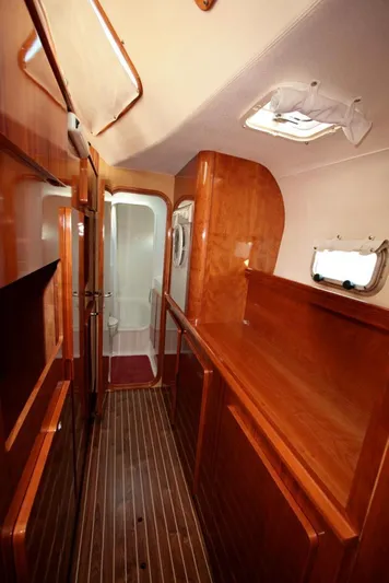 Osina Yacht Photos Pics Luxurious wooden interior of a 2000 Privilege 37 yacht, featuring sleek cabinetry and flooring.