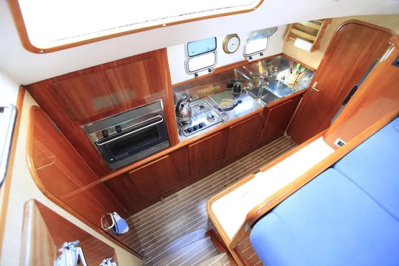 Osina Yacht Photos Pics Luxurious Privilege 37 yacht kitchen interior with wood finish and modern appliances, 2000 model.