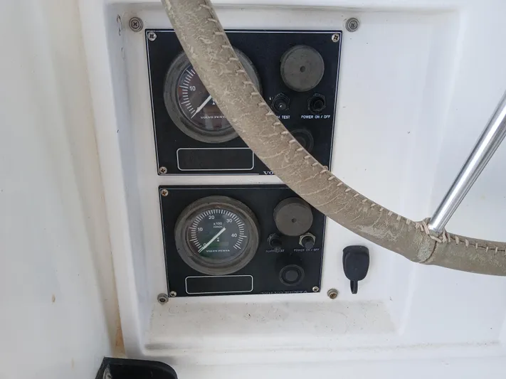 Osina Yacht Photos Pics Control panel of a 2000 Privilege 37 yacht with gauges and steering wheel.