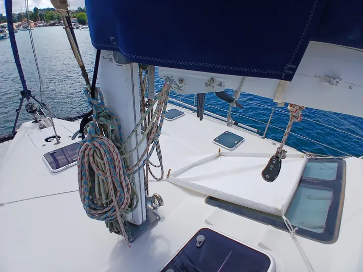 Osina Yacht Photos Pics Sailing yacht deck of 2000 Privilege 37, featuring ropes and hatches, on calm water.