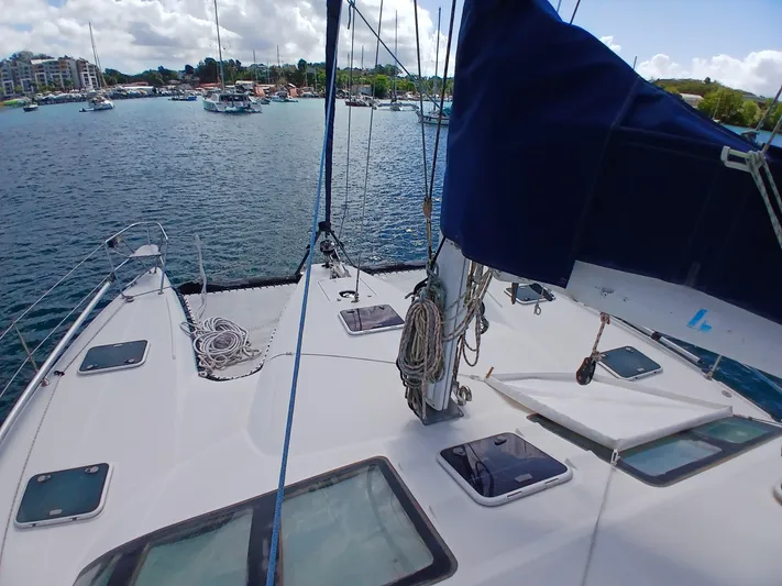 Osina Yacht Photos Pics Sailing catamaran Privilege 37, 2000 model, docked in a marina with clear skies.