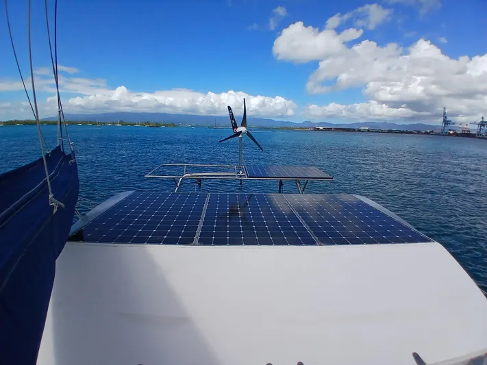 Osina Yacht Photos Pics Catamaran with solar panels and wind turbine on a sunny day, Privilege 37, 2000 model.