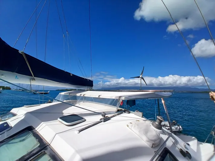 Osina Yacht Photos Pics Sailing catamaran Privilege 37 on blue ocean under clear sky, 2000 model.