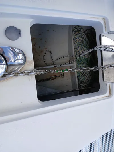 Osina Yacht Photos Pics Anchor chain locker on 2000 Privilege 37 yacht with visible rope and chain.