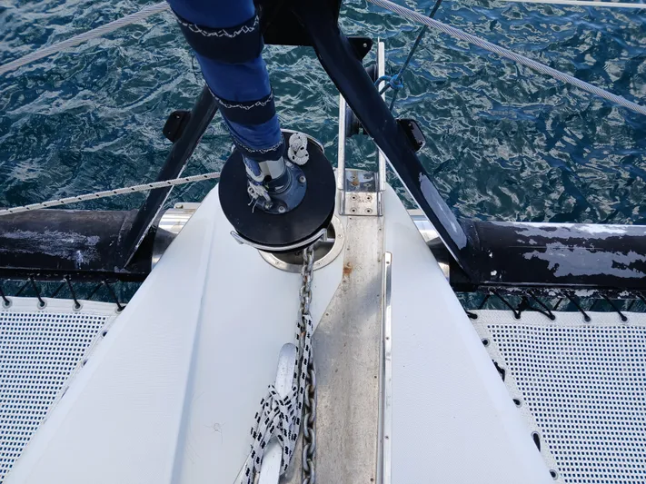 Osina Yacht Photos Pics Bow of Privilege 37 catamaran, 2000 model, with anchor chain over blue ocean.