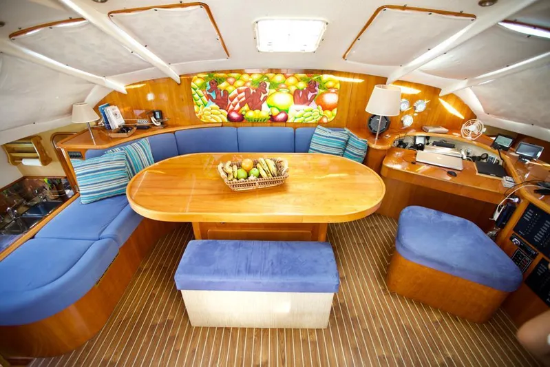 Osina Yacht Photos Pics Luxurious interior of 2000 Privilege 37 yacht with wooden table and blue seating.