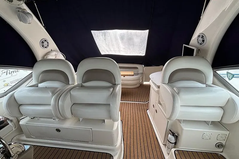  Yacht Photos Pics Interior of 2005 Sea Ray 340 Sundancer with white seating and wood flooring.