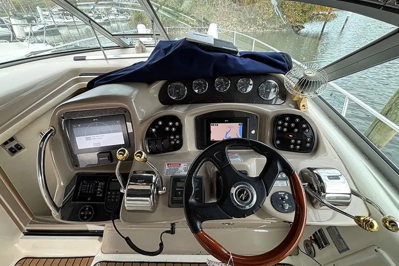  Yacht Photos Pics Helm of 2005 Sea Ray 340 Sundancer with navigation instruments and steering wheel.