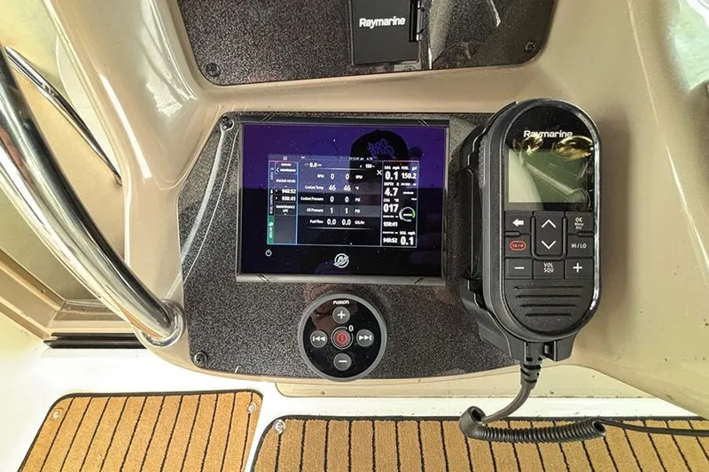  Yacht Photos Pics Helm of 2005 Sea Ray 340 Sundancer with Raymarine electronics and Fusion audio controls.