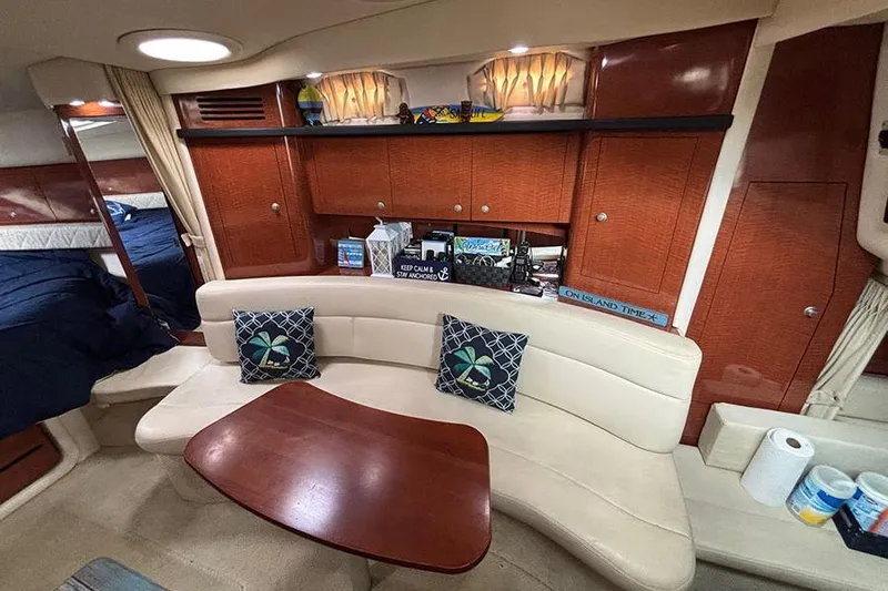  Yacht Photos Pics Interior of 2005 Sea Ray 340 Sundancer with cozy seating and wooden cabinetry.
