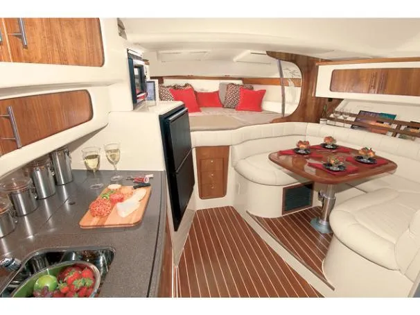  Yacht Photos Pics Luxurious interior of 2006 Grady-White Express 360 yacht with dining area and kitchenette.