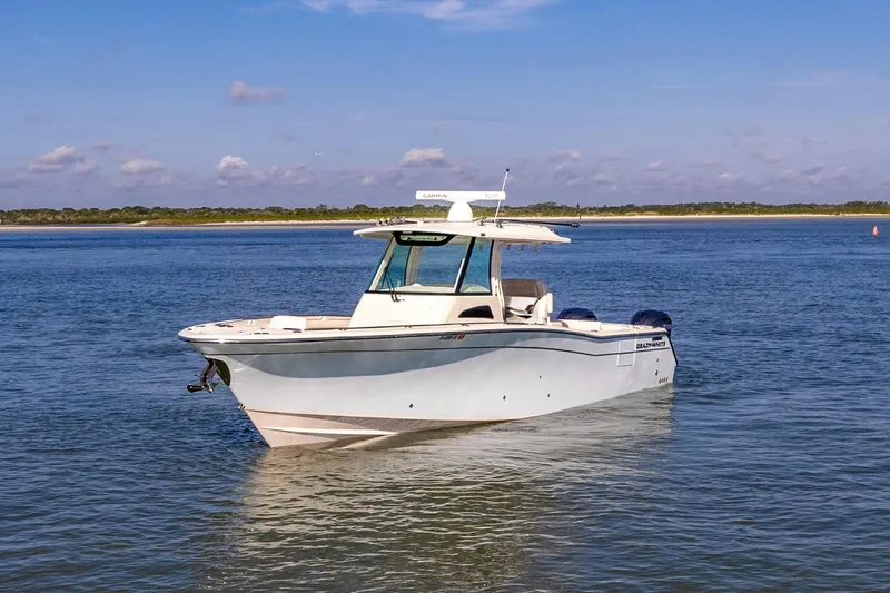  Yacht Photos Pics 2022 Grady-White Canyon 336 boat on calm water under blue sky.