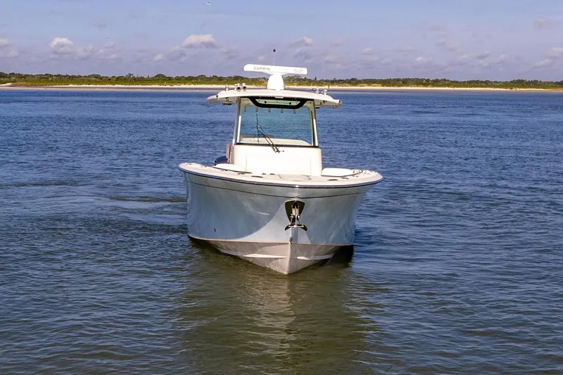  Yacht Photos Pics 2022 Grady-White Canyon 336 boat cruising on calm waters under a clear sky.