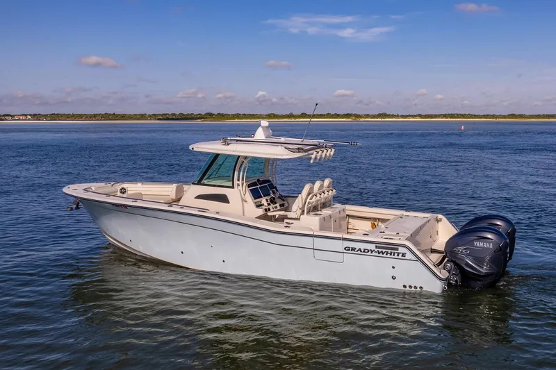  Yacht Photos Pics 2022 Grady-White Canyon 336 boat on calm water, side view.