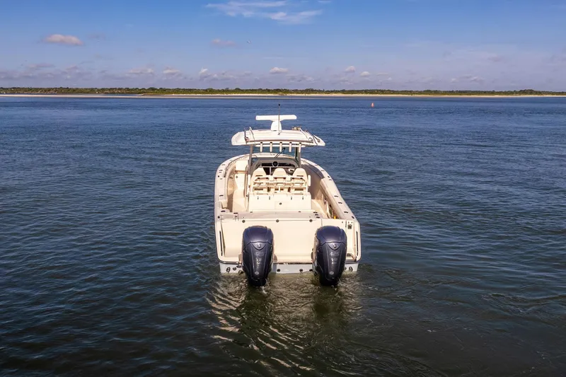  Yacht Photos Pics 2022 Grady-White Canyon 336 boat on calm water, rear view with twin engines.
