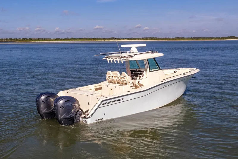  Yacht Photos Pics 2022 Grady-White Canyon 336 boat on calm water, featuring dual outboard engines.